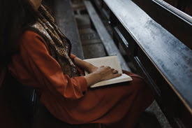 Woman Sitting at a Pew