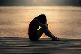 Little Girl consoling herself on a dock