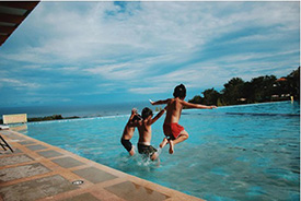 Children jumping into a pool