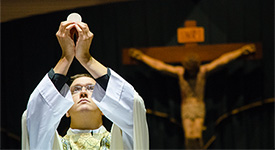 A priest blessing the eucharist