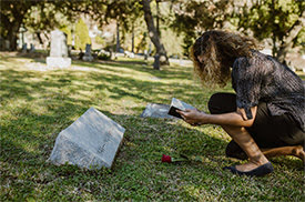 Woman Praying at a Grave