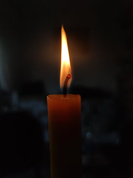 A hopeful lit candle