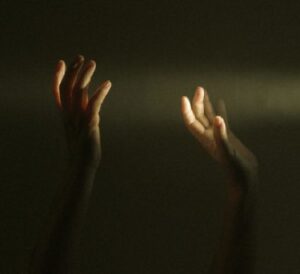 Hands Reaching to Light