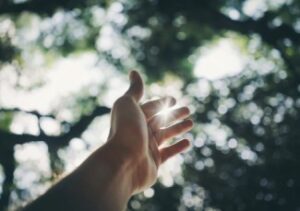 Hand Reaching to Sky