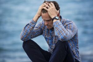 Man Holding Head In Deeep Thought