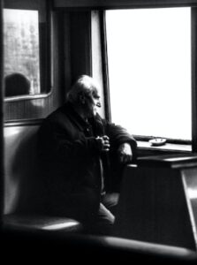 Man Looking Out Window