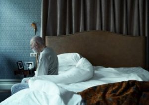 Man Sitting On Bed